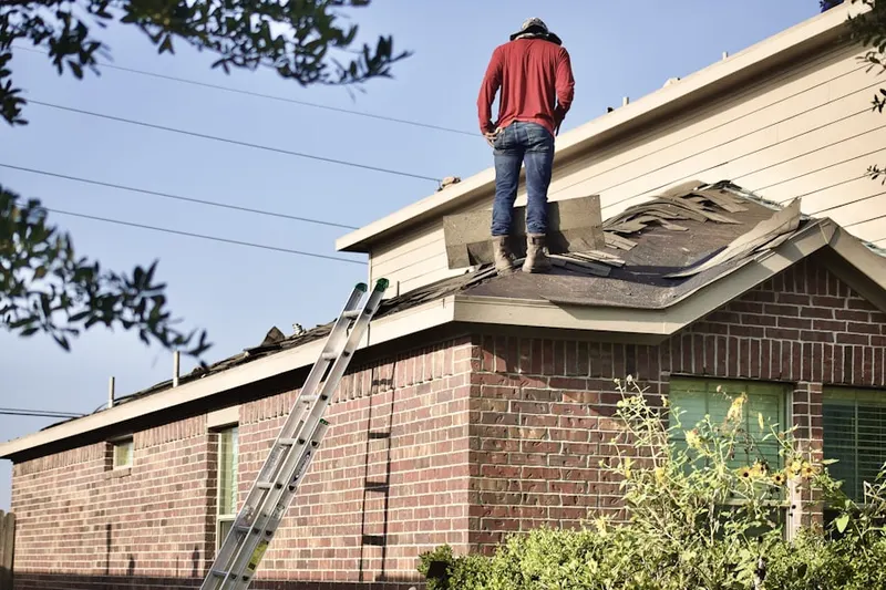 Professional roofer working on a residential roof in River Bend